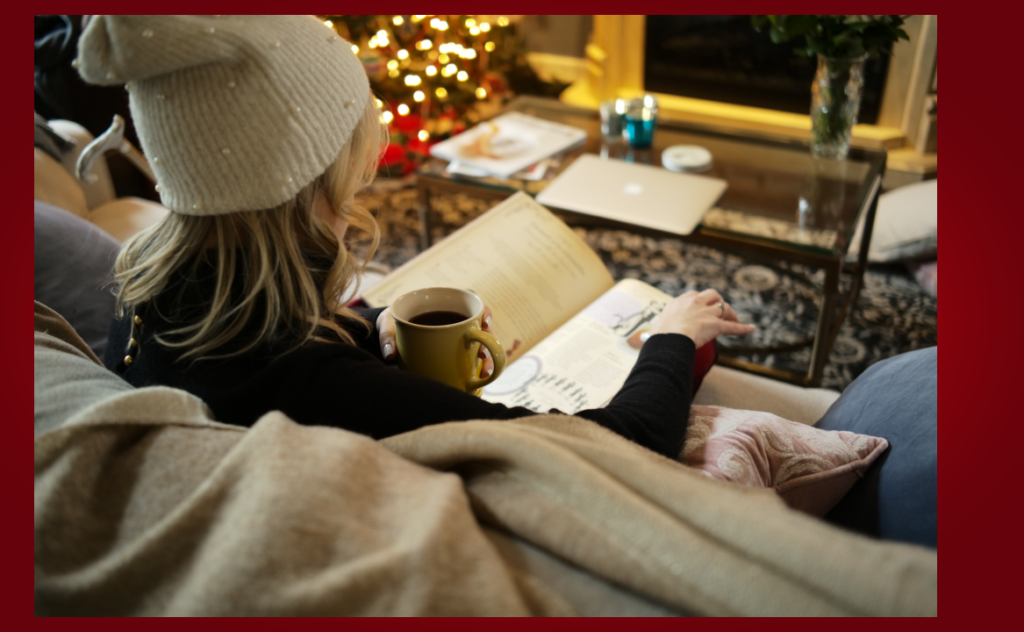 A woman with MS sits on a couch in front of a Christmas tree, determined to safely celebrate the holidays in the time of Covid.