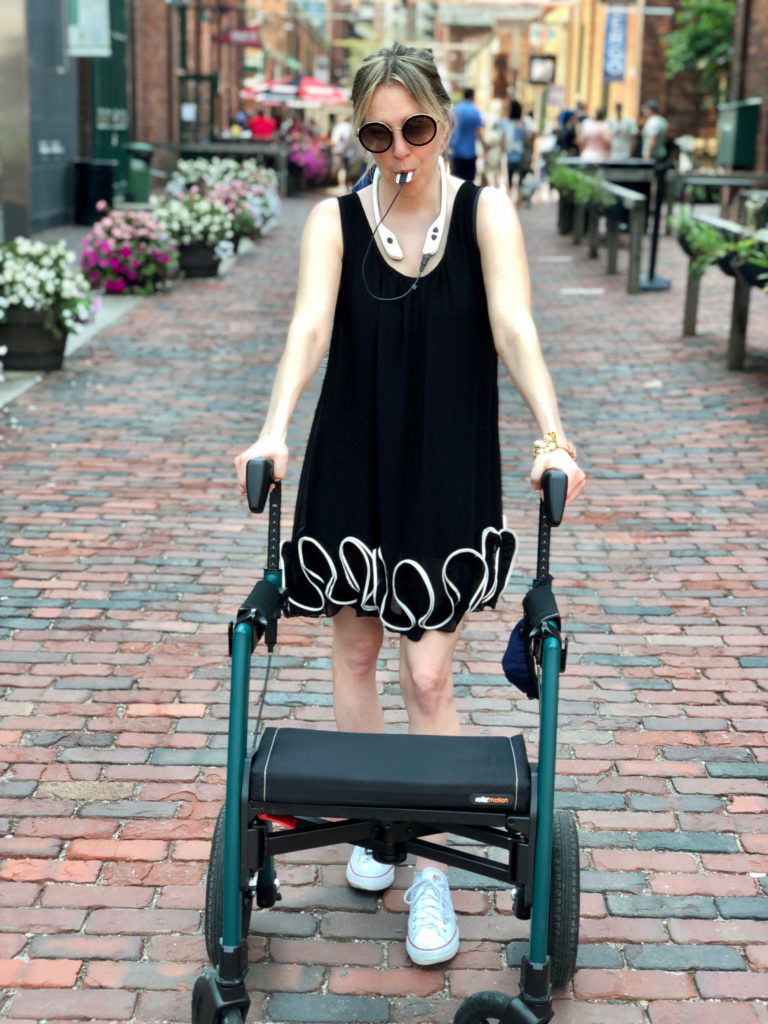 A woman with MS using the PoNS device and walking with a mobility aid.